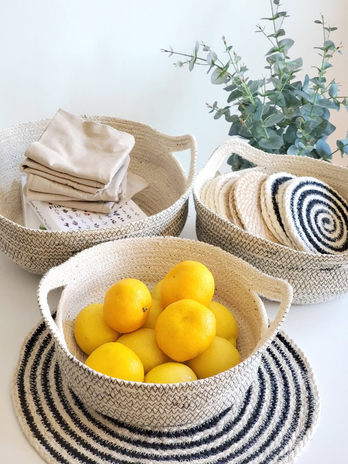 amari fruit bowl trio in black styled with fruit and accessories