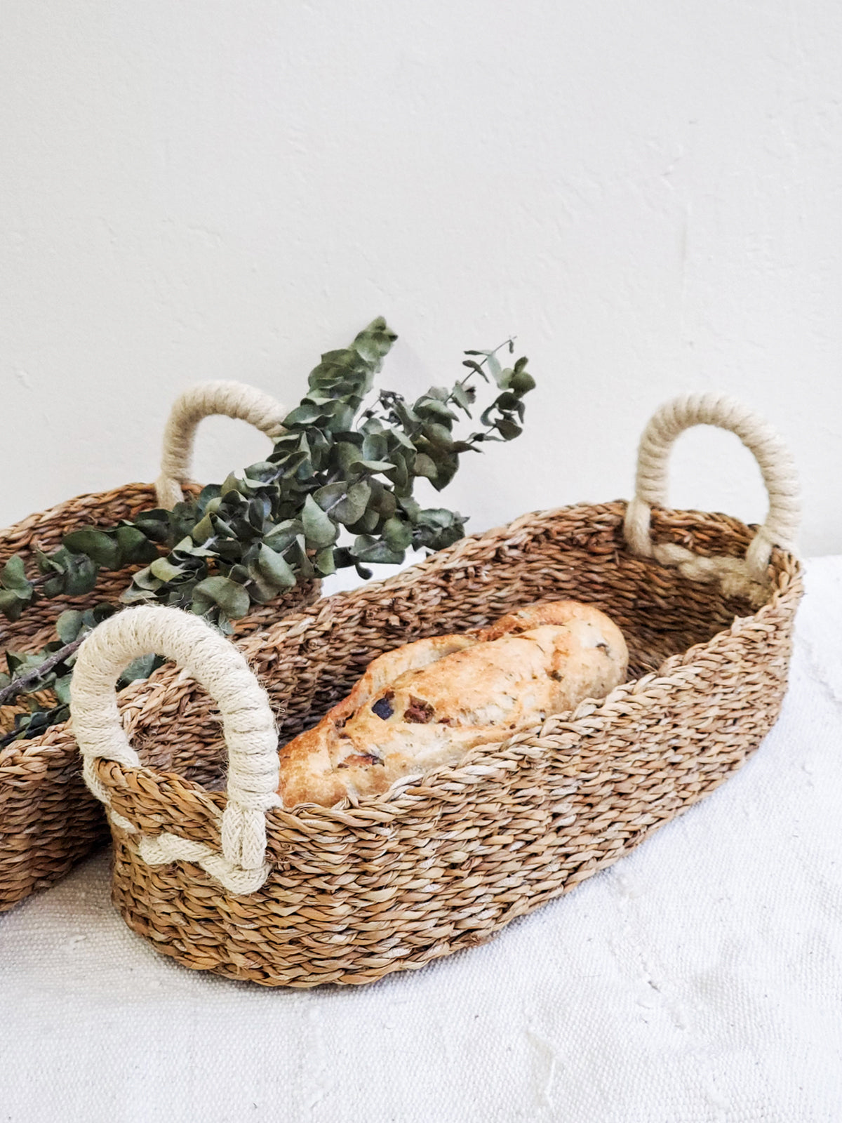 bread basket styled with bread and eucalyptus