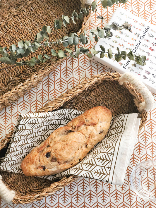 Printed tea towels styled with bread baskets and bread