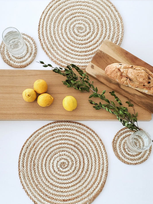 Brown and cream spiral placemats made from jute styled with breadboard and coasters.