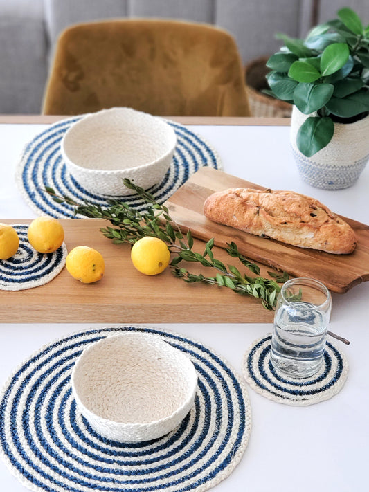 Spiral jute placemat in blue and cream styled with bread board and coasters